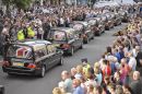 Seven Union flag covered hearses on the High Street of Wootton Bassett