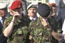 Serving soldiers react as the hearses leave Wootton Bassett High Street