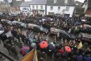 Rain or shine, crowds turn out to pay their respects to the fallen