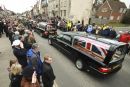 Five Union flag draped coffins roll through the High Street of Wootton bassett